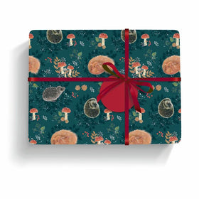 Wrapping paper with a hedgehog and toadstool design with a red ribbon and round red tag.