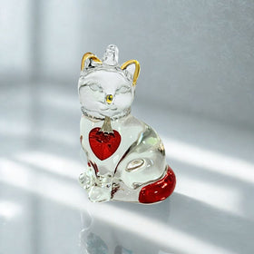Glass cat with red and gold colour on a white background.
