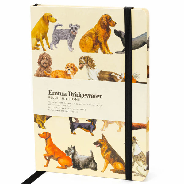 Emma Bridgewater 'Feels Like Home' hardcover notebook with a cream-colored cover decorated with various dog illustrations, secured with a black elastic band.