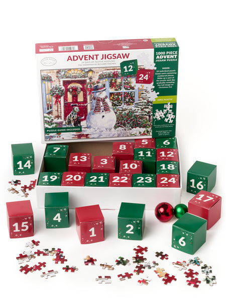 Advent jigsaw box with smaller number red and green boxes and loose jigsaw pieces on a white background.