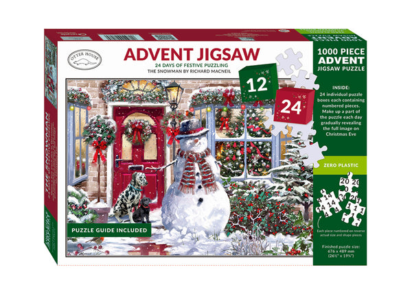 Boxed advent jigsaw of a snowman in front of a house with two dogs on a white background.