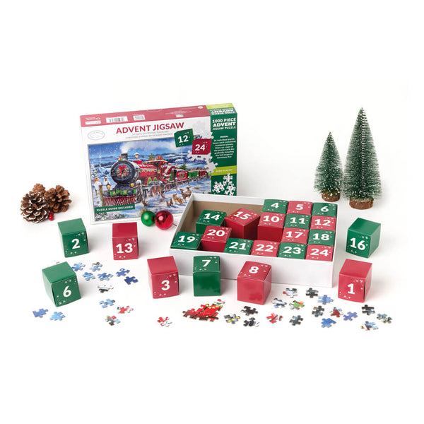 Advent jigsaw puzzle set with numbered red and green boxes, loose puzzle pieces, a pinecone, and two small decorative trees on a white background.
