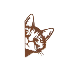 Peeking metal cat ornament on a white background.
