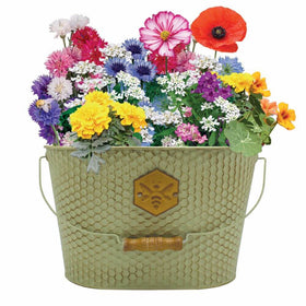 A green honeycomb-shaped wildflower trough planter with a variety of colorful flowers and a bee design in the center.