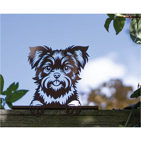 Rustic metal terrier dog fence ornament with a light blue background.