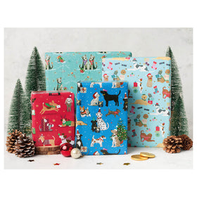 Red, light and dark blue giftwrap with fern trees and cones on a white background.
