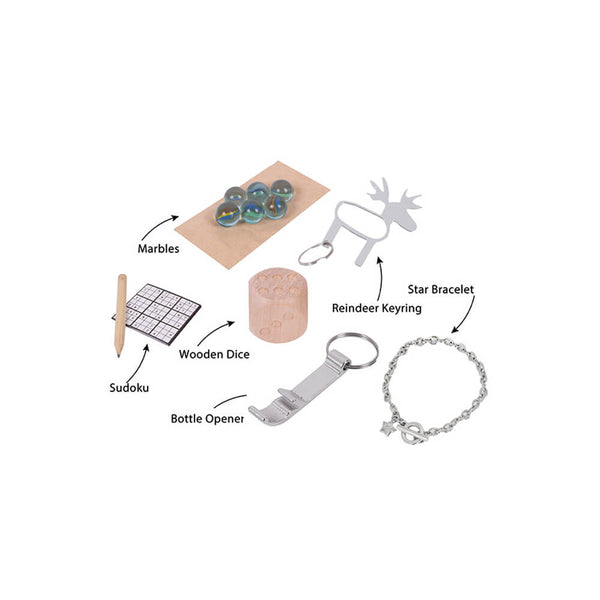 A gift set of 10 items arranged on a white background with black text labels pointing to each item: marbles, a wooden dice block with a wooden mallet, a bottle opener, a reindeer-shaped keyring, a star bracelet, and a Sudoku puzzle with a pen.