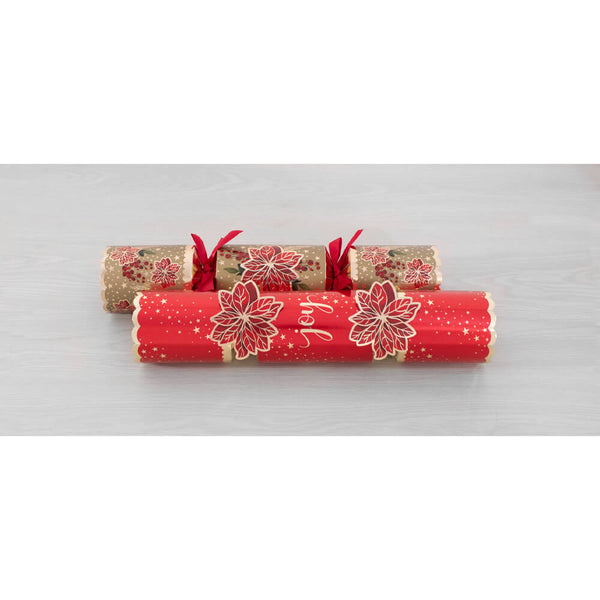 Two Christmas cracker ornaments with red and gold holiday designs, tied with red ribbons, displayed on a light gray surface.
