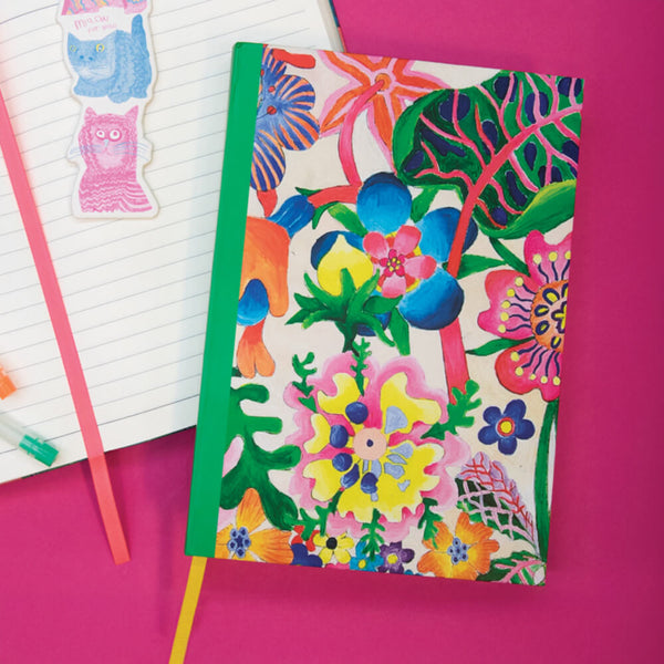 Colorful floral notebook on a pink background