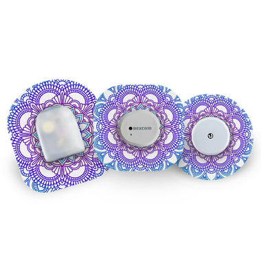 Three glucose monitoring devices with decorative blue mandala CGM patches on a white background