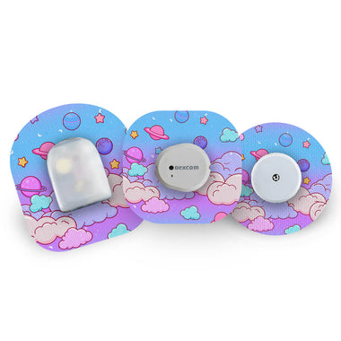 Three blood glucose monitoring devices with a colorful, cloud-patterned patches on a white background