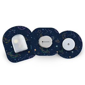 Three CGM sensors with galaxy design cgm patches on a white background