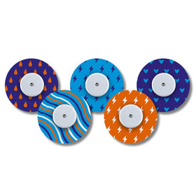 A collection of five round patches with a central adhesive hub, designed with various patterns including hearts, lightning bolts, and stripes, to be used with a Freestyle Libre blood glucose monitor.