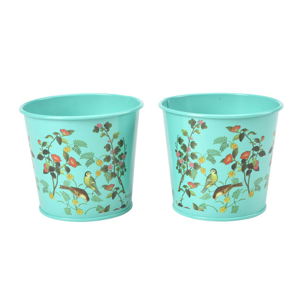 Two turquoise plant pots with floral and bird design on a white background