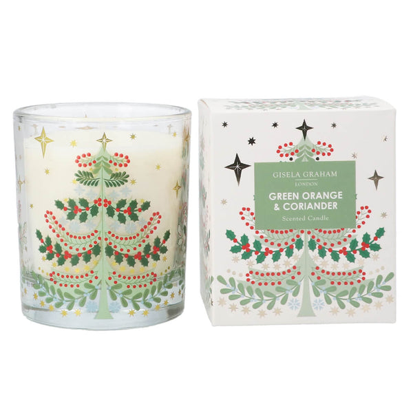 Decorative candle with Christmas tree design and matching packaging on a white background