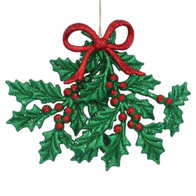 Decorative Christmas ornament with green holly leaves and red berries on a white background