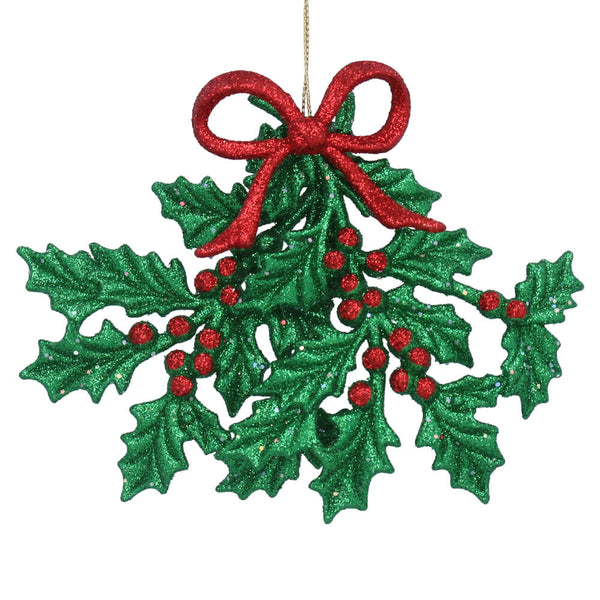 Decorative Christmas ornament with green holly leaves and red berries on a white background