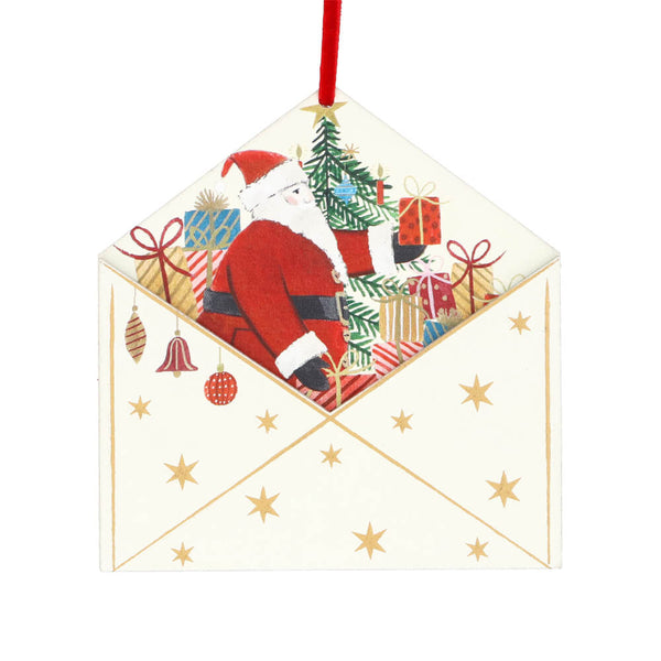 Decorative Christmas ornament with Santa Claus and presents inside a envelope on a white background