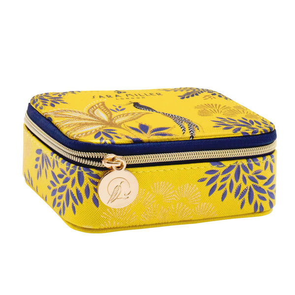 Yellow medication organiser with blue floral pattern and gold zipper on a white background