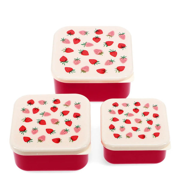Set of three square food containers with strawberry pattern lids on a white background