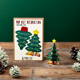 Pop-out Christmas tree decoration card featuring a decorated Christmas tree with colourful baubles, a gold star and presents, supplied with a blank Christmas greeting card and envelope.
